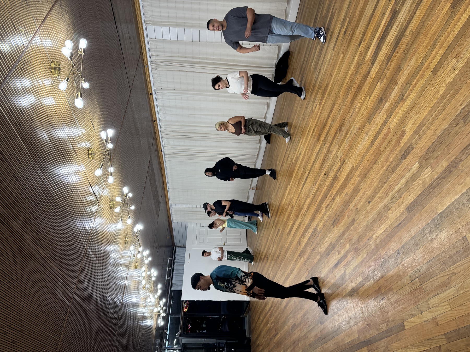 Jariel leading students through salsa steps in a dance class